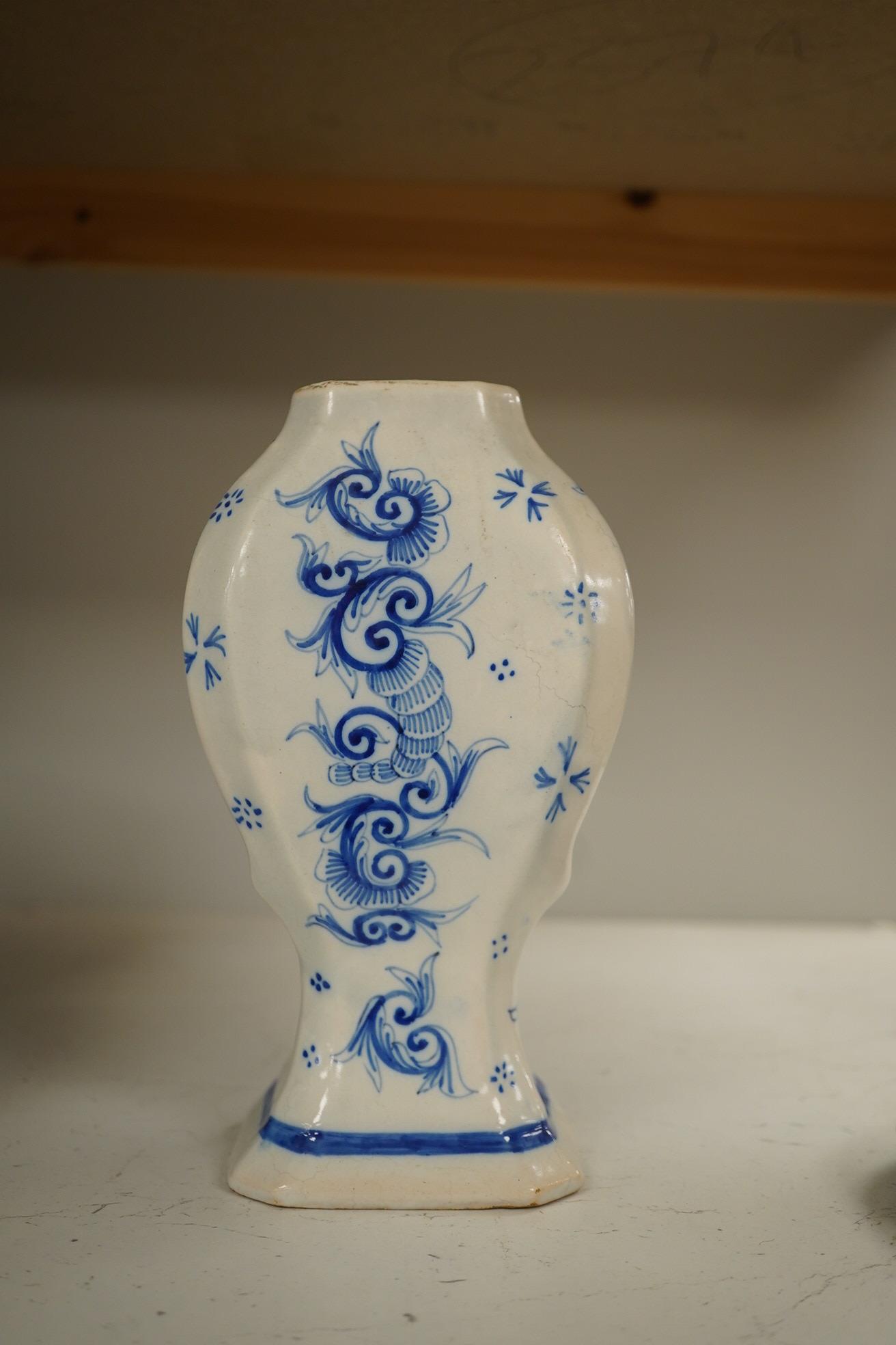 A 19th century Delft blue and white vase and a Watcombe Torquay pottery chamberstick, 19.5cm. Condition - both fair